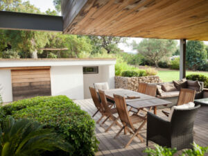 "Luxury modern villa with patio, furniture and green garden"